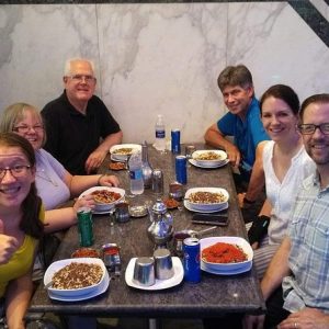 Tourists enjoying dining at a traditional restaurant during an Egyptian food tour.