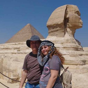 Couples taking a photo with the Sphinx and Pyramids in Giza