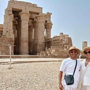wo couples explore the symmetrical architecture of Kom Ombo Temple in Egypt