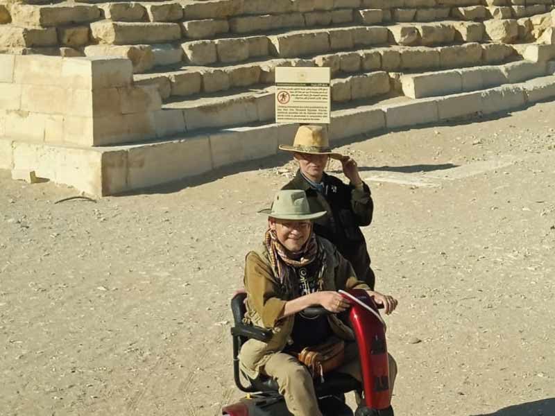  A father in a wheelchair and his daughter enjoy the view of the Pyramids of Giza 